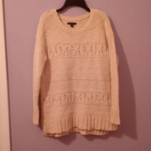 Cream-colored sweater.